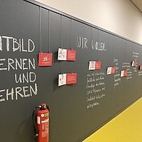 Bloick on a wall in the new building, on which excerpts from the Learning and Teaching mission statement have been written