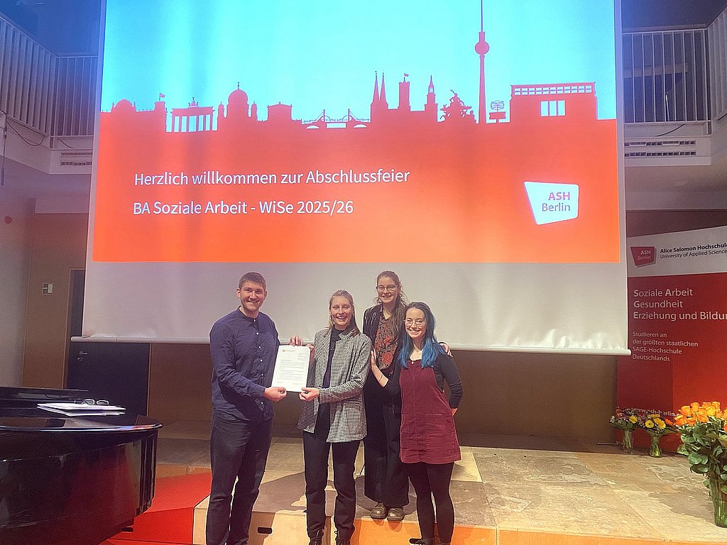 Das Foto zeigt Dr. Yannick Liedholz bei der Ehrung von drei Studierenden.