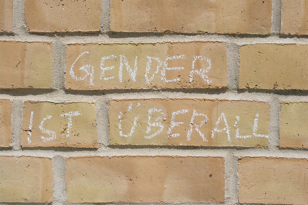 Mit Kreide ist der Spruch "Gender ist überall" an die Hauswand der ASH Berlin geschrieben